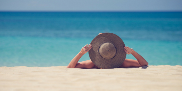 Woman wearing sun hat on beach pack