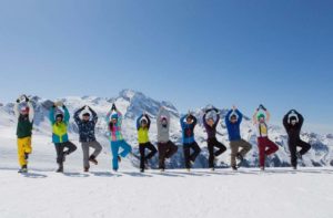 guests tree pose in a line on the slopes