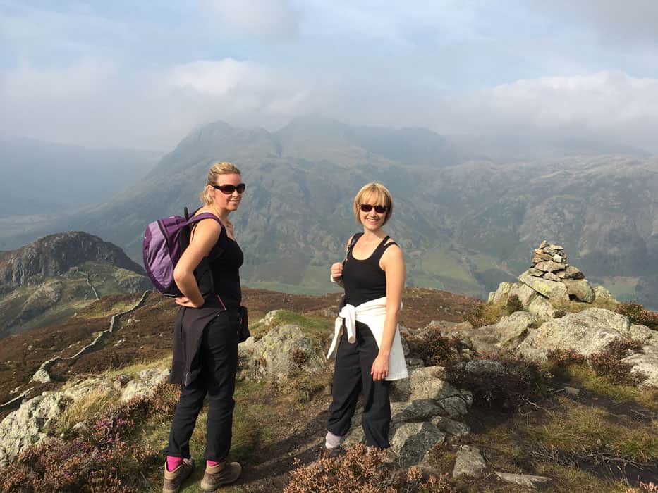 two friends top of mountain lake district