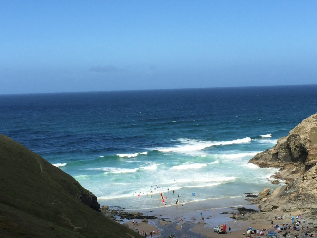 St Agnes beach cornwall bay and sea with waves and people in sea