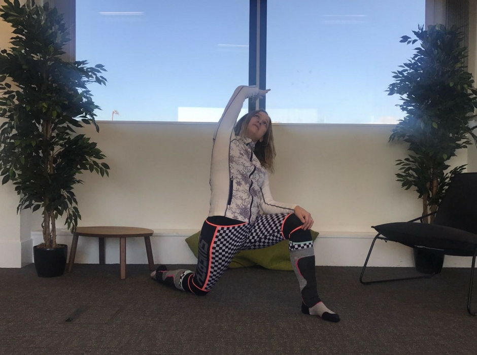 person doing lunge with side bend for post ski yoga