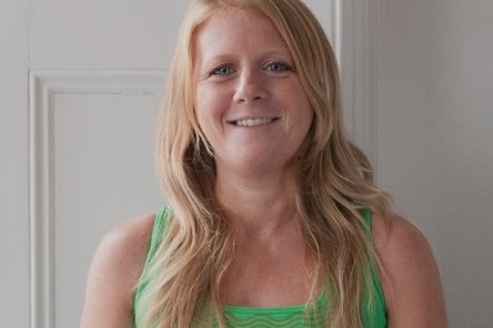 Yoga teacher Louise Windsor head shot against white backdrop