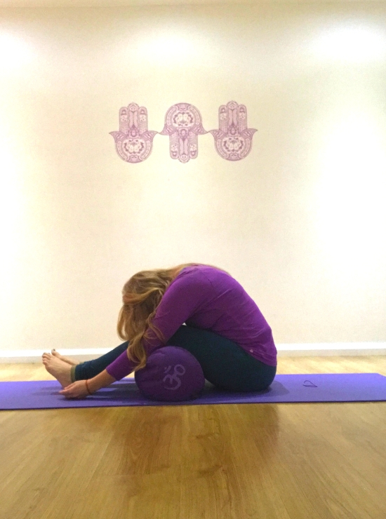 forward fold over bolster yin yoga pose ease back pain 