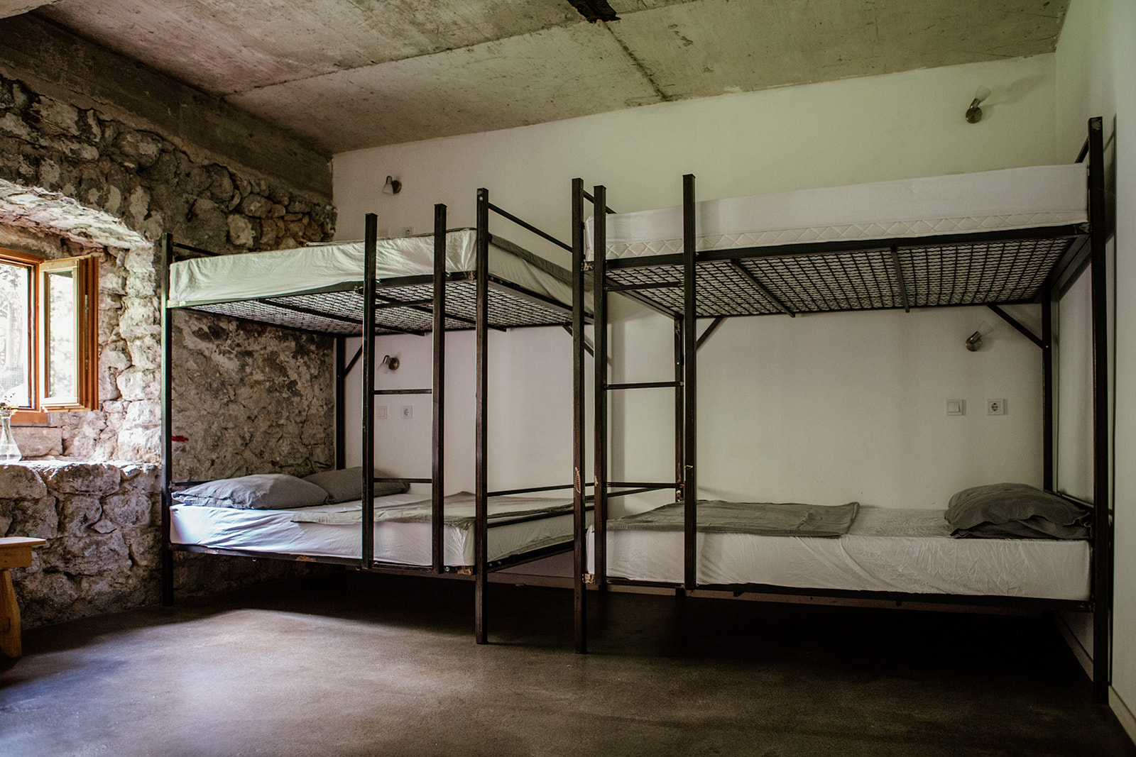two double bunk beds against wall - hiking yoga holiday montenegro