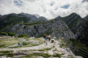 people standing on outdrop in mountains yoga holiday montenegro