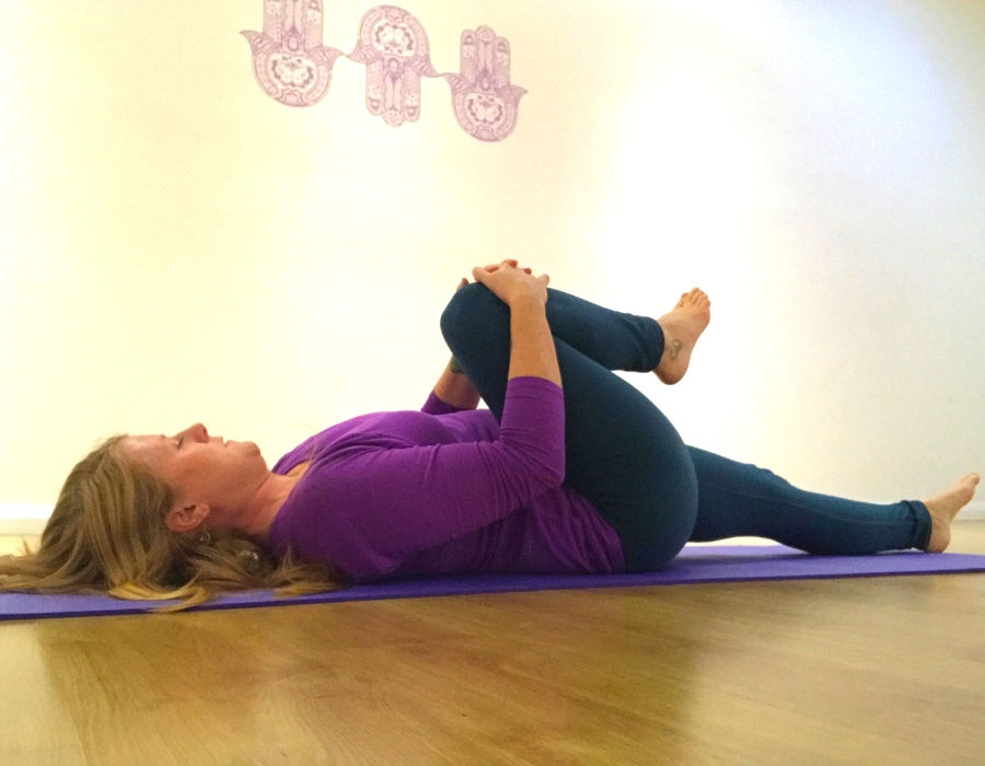 knee to chest pose yin yoga ease back pain