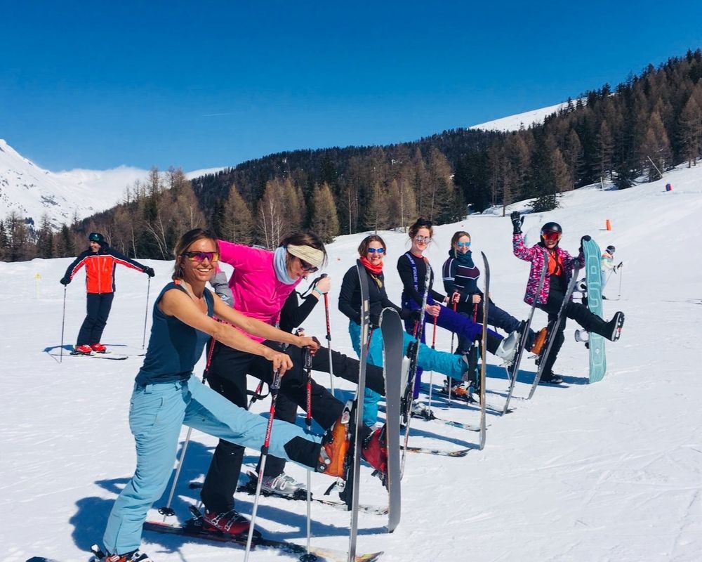 girls one leg up with skis on sunshine ski day