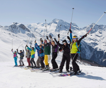 group skiers poles in air french alps