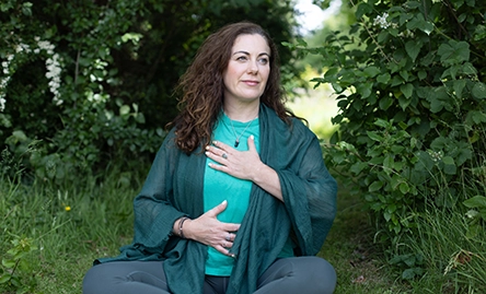 melanie may yoga teacher meditating outside