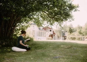 lady reading her book alone on the grass in sweden