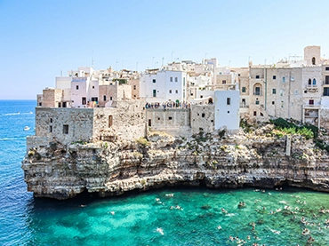 coastal cliff town in puglia with turquoise clear sea