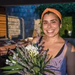 tania riscado vegan retreat chef holding bouquet of flowers
