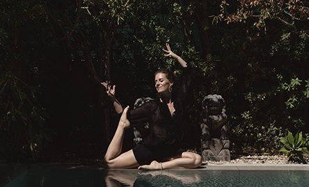 sara gracia yoga teacher pose by pool