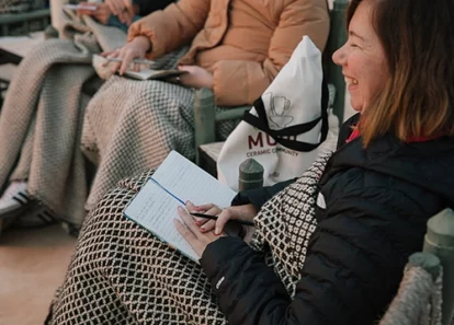 lady writing down her new year intentions during yoga retreat workshop