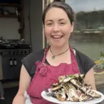 grace frain vegan chef smiling to camera with vegan dish